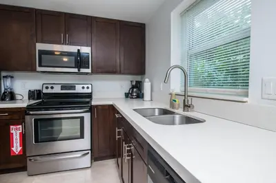 a kitchen with a stove and a sink and a microwave at Spacious entire Apartment with Free Parking in Hollywood