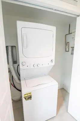 a white refrigerator freezer sitting inside of a room at Spacious entire Apartment with Free Parking in Hollywood