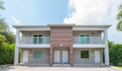 a house with white doors and a balcony at Spacious entire Apartment with Free Parking in Hollywood