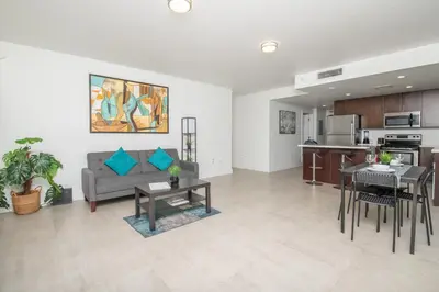 a living room with a couch and a table at Spacious entire Apartment with Free Parking in Hollywood