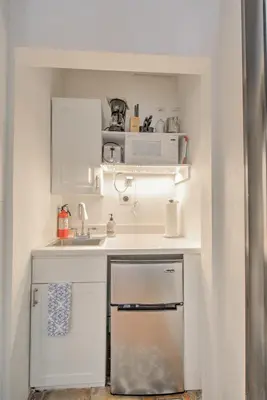 a small kitchen with a sink and a microwave at Efficiency 2 on water Las Olas, beach and free kayaks in Fort Lauderdale
