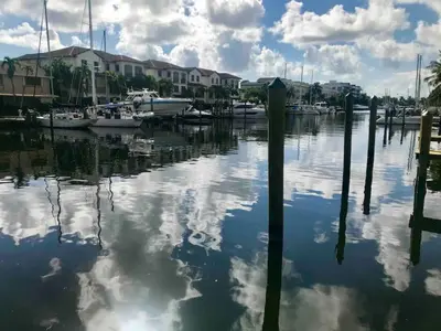 a body of water with boats in a marina at 1BR C direct on the water shared deck Free kayaks in Fort Lauderdale