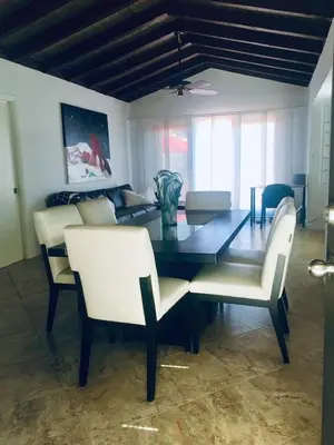 a dining room with a glass table and white chairs at 1BR C direct on the water shared deck Free kayaks in Fort Lauderdale
