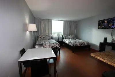 a room with two beds and a table and a couch at Penthouse in the sky in Miami Beach