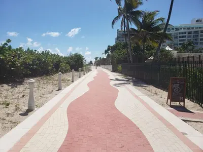 a red brick walkway on the beach with palm trees at Penthouse in the sky in Miami Beach