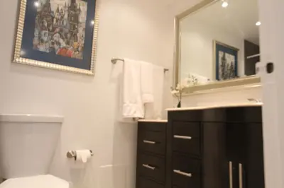 a bathroom with a sink and a toilet and a mirror at Penthouse in the sky in Miami Beach