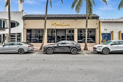 three cars parked in a parking lot in front of a store at 1 bedroom in the BEST location in South Beach ! in Miami Beach