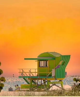 a green lifeguard shack on a beach with the ocean at 1 bedroom in the BEST location in South Beach ! in Miami Beach