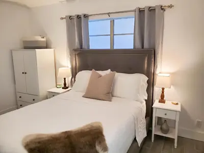 a bedroom with a large white bed with a window at Stylish & Newly-Renovated Suites near Las Olas in Fort Lauderdale