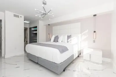 a white bedroom with a bed and a ceiling fan at Yacht Club at Aventura Lux 2 Bed 2 Bath Brand New 2021 in Aventura