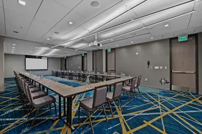 a large conference room with a long table and chairs at AC Hotel by Marriott Fort Lauderdale Airport in Dania Beach