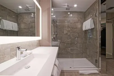 a bathroom with a sink and a shower at AC Hotel by Marriott Fort Lauderdale Airport in Dania Beach