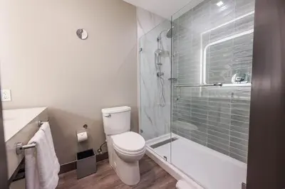 a bathroom with a toilet and a glass shower at Marriott Fort Lauderdale Airport in Dania Beach