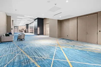 an empty office lobby with blue and yellow carpeted floors at Marriott Fort Lauderdale Airport in Dania Beach