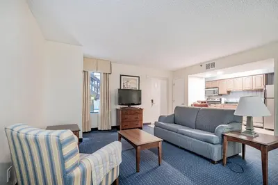 a living room with a couch and a table at Doral Inn & Suites Miami Airport West in Miami