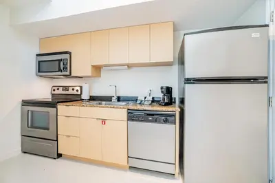 a kitchen with a refrigerator and a sink at Doral Inn & Suites Miami Airport West in Miami