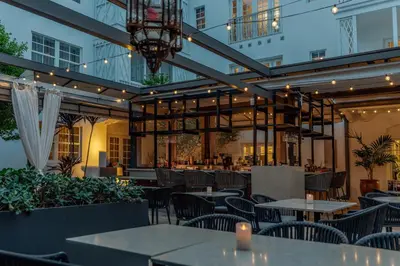 a restaurant with tables and chairs and a building at Iberostar Waves Miami Beach in Miami Beach