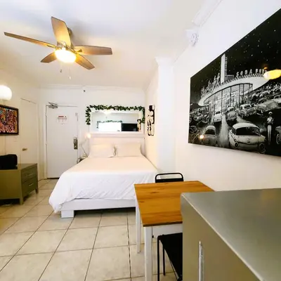 a bedroom with a bed and a ceiling fan at OCEAN FRONT BEACH PADS---South Beach in Miami Beach