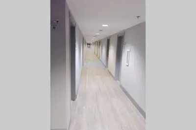 an empty hallway with white walls and wooden floors at OCEAN FRONT BEACH PADS---South Beach in Miami Beach