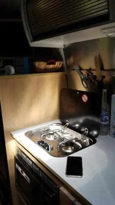 a stove top oven sitting on top of a kitchen counter at Airstream in the Center of it All in Miami