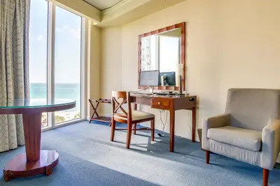 a room with a desk and a chair and a window at Pool and Tennis Beachfront Florida Condo! in Miami Beach