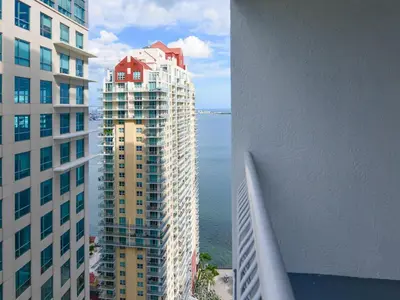 an aerial view of a tall building next to the water at Cozy and Bohemian Studio in Brickell in Miami