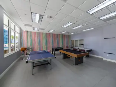 a large room with two ping pong tables in it at Cozy and Bohemian Studio in Brickell in Miami