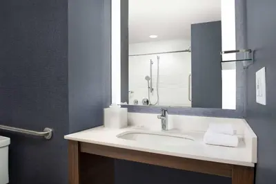 a bathroom with a sink and a mirror at Residence Inn Doral Mall Area in Doral