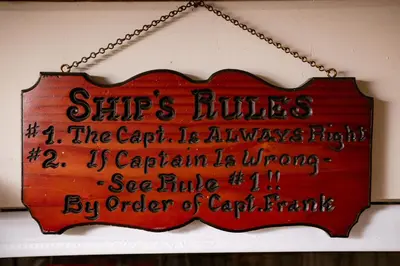 a sign hanging from a chain on a wall at The Rum Locker - 1 King - 2 Twins - Private home and Patio - Sleeps 4 in Fort Lauderdale