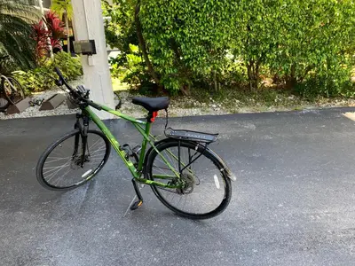 a green bike parked on the street at Walk to the Beach at Sunny Isles in Miami Beach