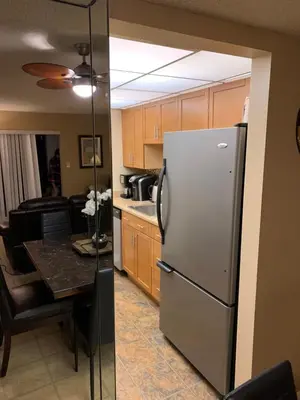 a kitchen with a refrigerator and a table in it at Walk to the Beach at Sunny Isles in Miami Beach
