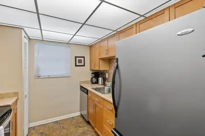 a kitchen with a refrigerator and a sink at Walk to the Beach at Sunny Isles in Miami Beach