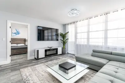 a living room with a couch and a table at AMAZING 2BR 2BA NEWLY RENO BEACHFRONT APT W/BEACH VIEW in Hollywood