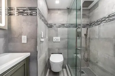 a bathroom with a toilet and a glass shower at AMAZING 2BR 2BA NEWLY RENO BEACHFRONT APT W/BEACH VIEW in Hollywood