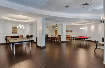 a large room with a ping pong table and chairs at Spacious 1BR on the Beach, The Tides, Hollywood,FL in Hollywood