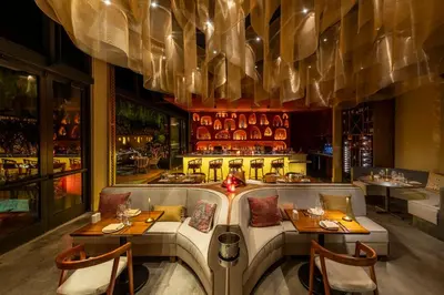 a dining room with two tables and a bar at Sentral Wynwood in Miami