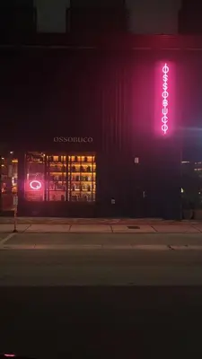 a neon sign on the side of a building at night at Sentral Wynwood in Miami