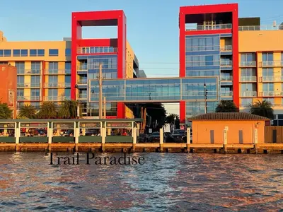 a train station next to a building next to the water at COSTA HOLLYWOOD Steps to Beach in Hollywood