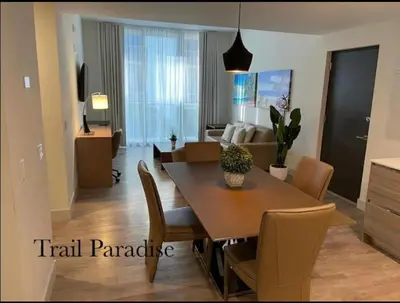 a dining room and living room with a table and chairs at COSTA HOLLYWOOD Steps to Beach in Hollywood