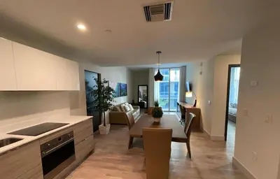 a kitchen and living room with a table and a couch at COSTA HOLLYWOOD Steps to Beach in Hollywood