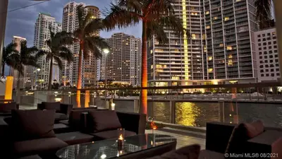 a restaurant with a view of a city at night at Downtown Miami Brickell Bay & Pool View 4 Bedrooms in Miami