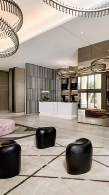 a lobby with black chairs on the floor at HYDE HOUSE 1906 HALLENDER MIAMI in Hollywood