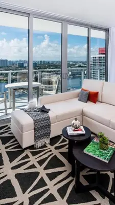 a living room with a couch and a large window at HYDE HOUSE 1906 HALLENDER MIAMI in Hollywood