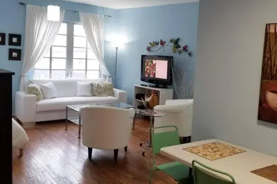 a living room with a white couch and a tv at *530 BEACH PAD-OCEAN DRIVE* in Miami Beach