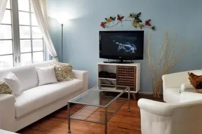 a living room with a white couch and a tv at *530 BEACH PAD-OCEAN DRIVE* in Miami Beach