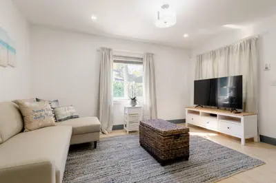 a living room with a couch and a flat screen tv at Casa Madeira 2@ the heart of Miami Design District in Miami