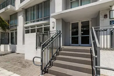 a building with stairs in front of a building at Roami at Grove 27 in Miami