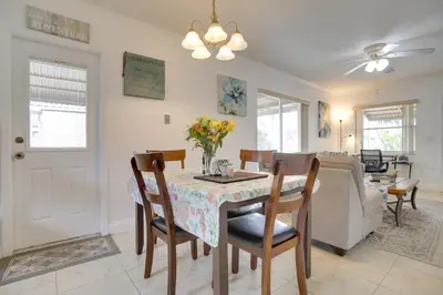 a dining room and living room with a table and chairs at 2 Mi to Boardwalk Home with Grill in Dania Beach! in Dania Beach