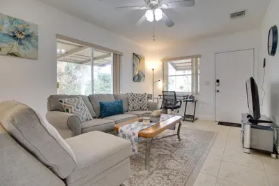 a living room with a couch and a table at 2 Mi to Boardwalk Home with Grill in Dania Beach! in Dania Beach