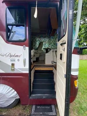 an open door of a red and white van with stairs at Remodeled and Comfortable RV - FREE PARKING in Miami